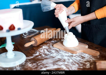 girl preparing cup cake according recipes, close up cropped photo. Stock Photo