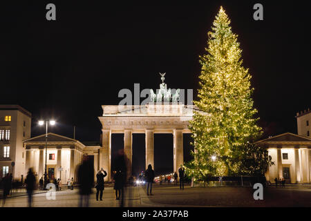 Illuminated Neoclassical Brandenburg Gate (Brandenburger Tor) and Christmas Tree as viewed from the Pariser Platz, Mitte, Berlin, Germany Stock Photo