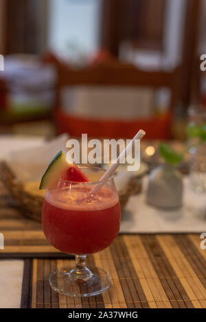 Cocktail served on a table with restaurant in the background Stock Photo