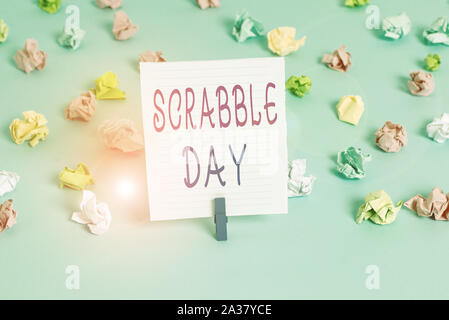 Conceptual hand writing showing Scrabble Day. Concept meaning a day to celebrate the popular board game created in 1938 Colored crumpled papers empty Stock Photo