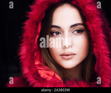 Beautiful young woman wearing red fur coat Stock Photo