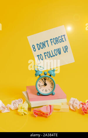 Text sign showing 8 Don T Forget To Follow Up. Business photo showcasing asking someone to keep connection with others Alarm clock sticky note paper b Stock Photo