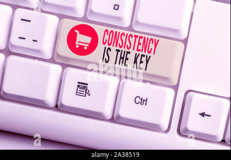 Handwriting text Consistency Is The Key. Conceptual photo full Dedication to a Task a habit forming process White pc keyboard with empty note paper ab Stock Photo