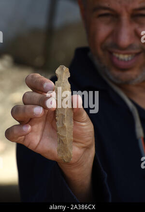 En Esur, Israel. 06th Oct, 2019. A man holds a knife, discovered during excavations of a vast 5,000 cosmopolitan and planned city from the Early Bronze Age, one of the first and largest of the ancient Near East, excavated by the Israeli Antiquities Authority in En Esur, Israel, on Sunday, October 6, 2019. The En Esur archaeological site, located near Wadi Ara, was discovered prior to the construction of a highway interchange and revealed a massive city where 6,000 people lived. Photo by Debbie Hill/UPI Credit: UPI/Alamy Live News Stock Photo