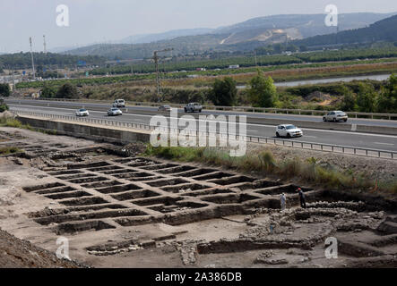 En Esur, Israel. 06th Oct, 2019. Cars drive on a highway past part of a vast 5,000 year old cosmopolitan and planned city, one of the first and largest of the ancient Near East, excavated by the Israeli Antiquities Authority in En Esur, Israel, on Sunday, October 6, 2019. The En Esur archaeological site, located near Wadi Ara, was discovered prior to the construction of a highway interchange and revealed a massive city where 6,000 people lived. Photo by Debbie Hill/UPI Credit: UPI/Alamy Live News Stock Photo