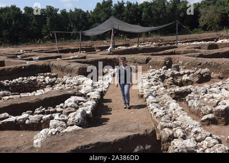 En Esur, Israel. 06th Oct, 2019. Dr. Dina Shalem, Excavation Director, walks on a 5,000 year old alley, undercovered in a cosmopolitan and planned city, one of the first and largest of the ancient Near East, excavated by the Israeli Antiquities Authority in En Esur, Israel, on Sunday, October 6, 2019. The En Esur archaeological site, located near Wadi Ara, was discovered prior to the construction of a highway interchange and revealed a massive city where 6,000 people lived. Photo by Debbie Hill/UPI Credit: UPI/Alamy Live News Stock Photo