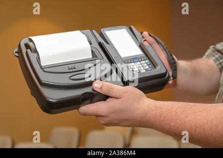 Man Holding Mobile Barcode Printer and Reader Computer Device Stock Photo