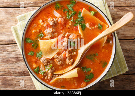 Homemade thick lasagna soup with minced meat closeup in a plate. Horizontal top view from above Stock Photo