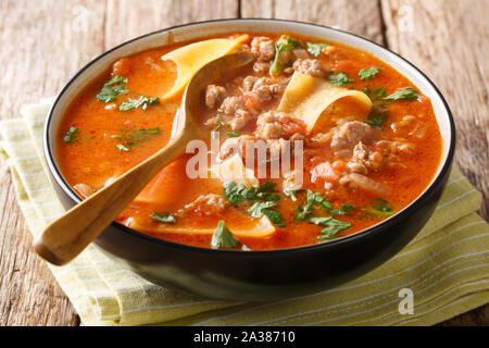 Portion of rich lasagna soup close-up in a plate on the table. horizontal Stock Photo