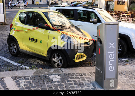 Electric car sharing (Share'ngo) car connected to charging station in Trasteve, Rome, Italy Stock Photo