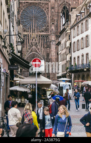 Strasbourg, France - July 26, 2017. Tourists walk along the street of Strasbourg near the cathedral Stock Photo