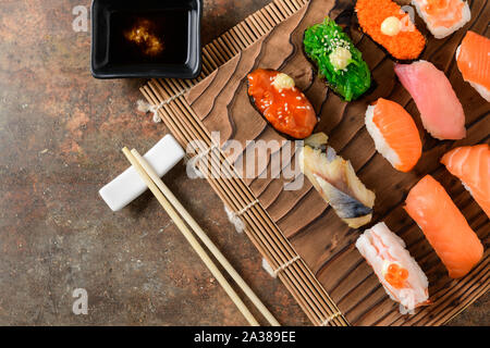 close up of sashimi sushi set with chopsticks and Shoyu sauce on old brown stone background, Japanese food Stock Photo