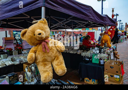 Redcar weekly  Market on a wet autumn day stall selling general goods with a large Teddy Bear on display Stock Photo