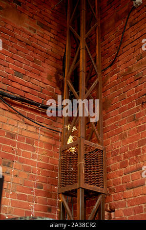 The wall of the loft is made of red brick with metal fittings.The style of industrial Stock Photo