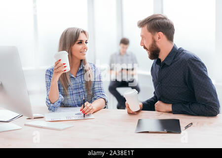 young employees discussing financial documents during coffee break Stock Photo