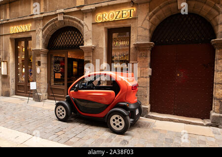 A Renault Twizy (electric car) parked outside the Bonnat Crozet chocolate shop on Rue de Boeuf in the old town historic district of Lyon, France. Stock Photo