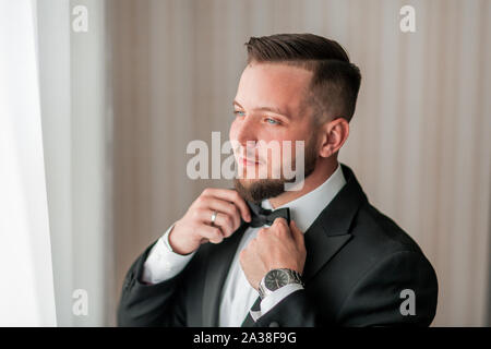 close up. serious man buttoning his jacket. Stock Photo
