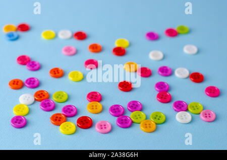 Many colorful buttons on blue background. Selective focus. Stock Photo