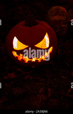 Halloween pumpkin with a scary evil face Stock Photo