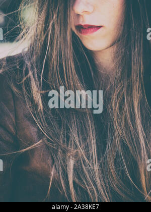 woman with long brown hair with red lipstick Stock Photo