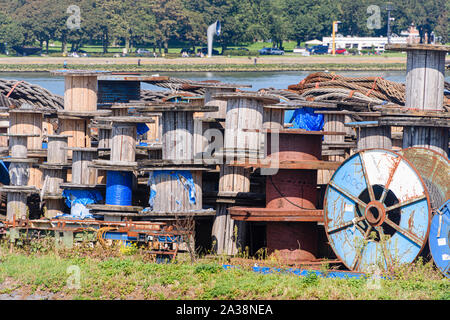 Empty wooden spools, used for transporting large electricity and telecommunications cables, lie at Rotterdam Harbour, Rotterdam, Netherlands Stock Photo