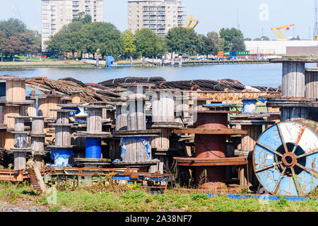 Empty wooden spools, used for transporting large electricity and telecommunications cables, lie at Rotterdam Harbour, Rotterdam, Netherlands Stock Photo