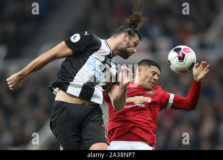 Newcastle United's Andy Carroll (left) and Manchester United's Marcos Rojo battle for the ball during the Premier League match at St James' Park, Newcastle. Stock Photo