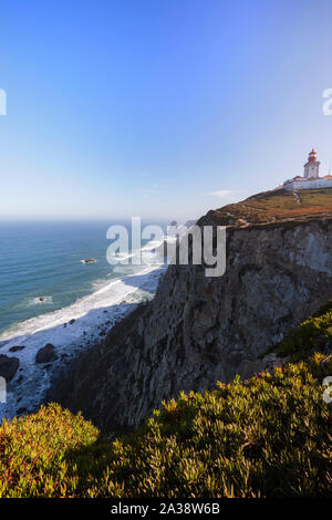Scenic view of Atlantic Ocean, lighthouse and rugged coast at Cabo da Roca, the westernmost point of continental Europe, in Portugal. Stock Photo