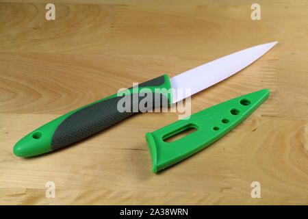 Green and black ceramic knife with its protection Stock Photo