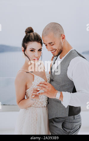 beautiful bride and groom in their summer wedding day on greek island Santorini