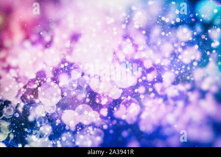 Flying snowflakes on a light blue background. Winter Abstract snowflakes. Falling snow. Stock Photo