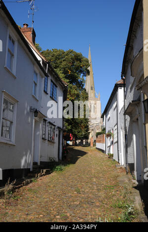 Stoney Lane, Thaxted, Essex, is a narrow cobbled street leading beside the Guildhall up to the parish church, providing a marvellous view of the tower Stock Photo
