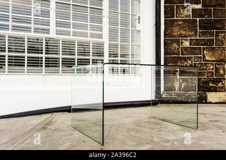 A glass table acts as the glass ceiling at the Old Castle Brewery built in 1901 in the Cape Town city suburb of Woodstock in South Africa Stock Photo