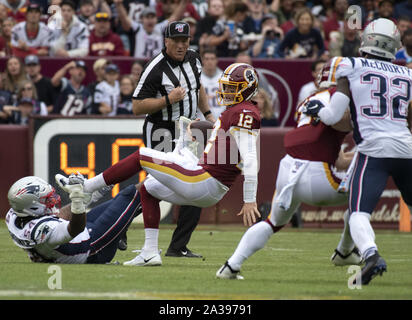 Landover, Maryland, USA. 6th Oct, 2019. Washington Redskins quarterback Colt McCoy (12) is sacked by New England Patriots outside linebacker Dont'a Hightower (54) in second quarter action at FedEx Field in Landover, Maryland on Sunday, October 6, 2019. Also defending on the play is New England Patriots free safety Devin McCourty (32) Credit: Ron Sachs/CNP/ZUMA Wire/Alamy Live News Stock Photo