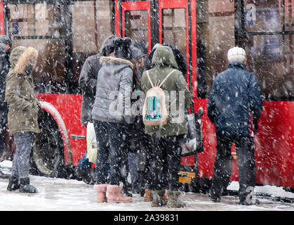 Belgrade, Serbia - January 3, 2019:  People waiting for public transport at bus stop on a snowy winter day Stock Photo