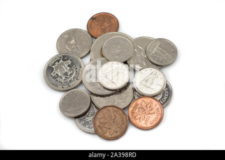 An assorted pile of modern Canadian coins isolated, up close in macro, on a clean white background Stock Photo