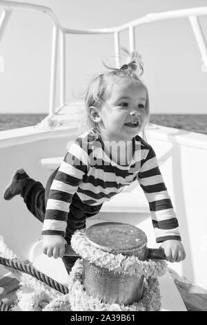 Baby enjoy sea cruise. Boy sailor travel sea. Boy sea yacht travel around world. Sea traveller. Time for adventure. If you choose follow animators steps every day will seem like never ending party. Stock Photo