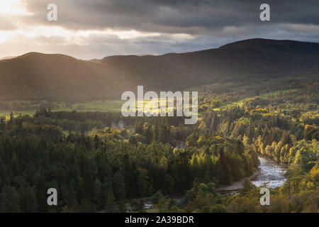 Rays of Sunshine Light Up Balmoral Castle & the River Dee in Late Afternoon as Storm Clouds Approach Stock Photo