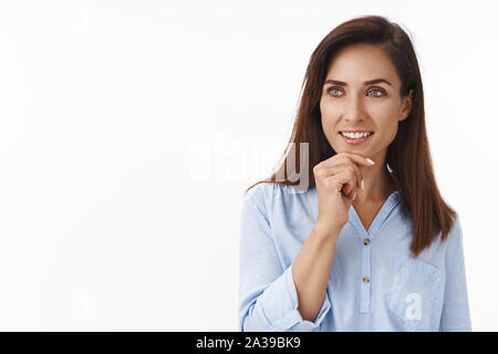 Curious entertained good-looking adult 30s woman pondering choice, touch chin intrigued, look left copyspace interested, thoughtful making decision Stock Photo