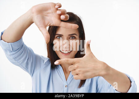Close-up inspired middle-aged female entrepreneur explain own vision, create picture, show finger frames and look through imaging shooting scene Stock Photo