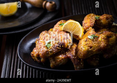 Spicy chicken wings with garlic, sesame and lemon marinade in Asia style Stock Photo