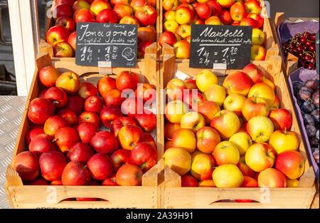 Fresh apples with price tags in wooden boxes at a market stall, Germany Stock Photo