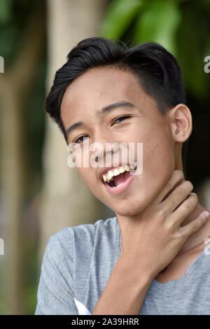 Asian Male Youngster With Sore Throat Stock Photo