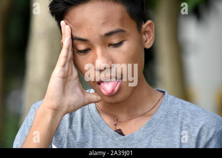 A Sick Handsome Diverse Male Youngster Stock Photo