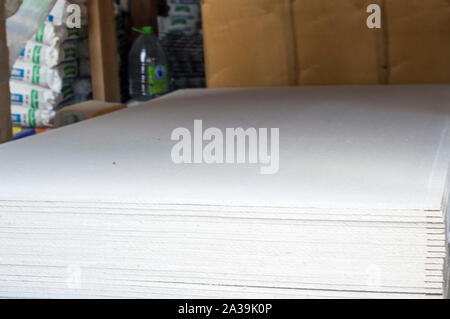 Drywall sheets, are in stock for sale to the public. Nearby are gypsum fiber sheets. Russia Stock Photo