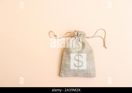 Money bag on light beige natural background Stock Photo