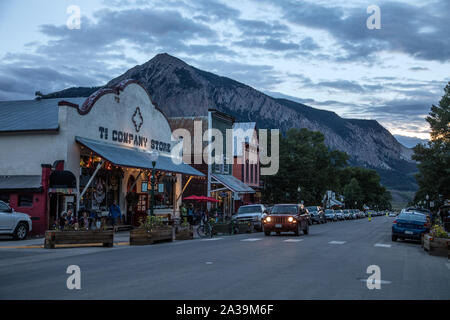 Scene along Elk Avenue, the main street of Crested Butte, a town heavily populated during ski season located high in the Rocky Mountains in Gunnison County, Colorado. In the distance is Mount Crested Butte, which gave the town its name Stock Photo