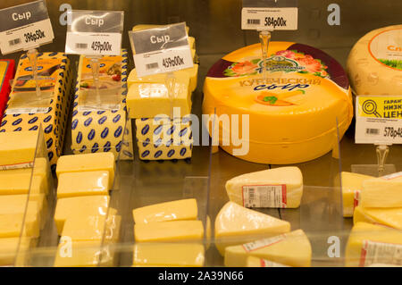 Types of cheese laid out for sale on the counter. Parmesan, Brewer, Russian, Dutch, Kostroma, processed and sausage cheeses. Russia. Stock Photo