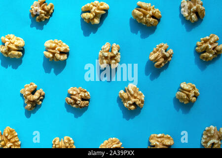 Walnuts pattern on blue background. Walnuts flat lay, top view. Stock Photo