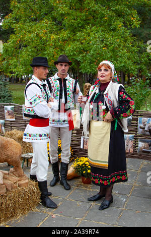 Chisinau, Moldova - October 5, 2019: Young men and woman in traditional Balkanic costumes at a festival in Chisinau, the capital of Moldova. Rest in t Stock Photo